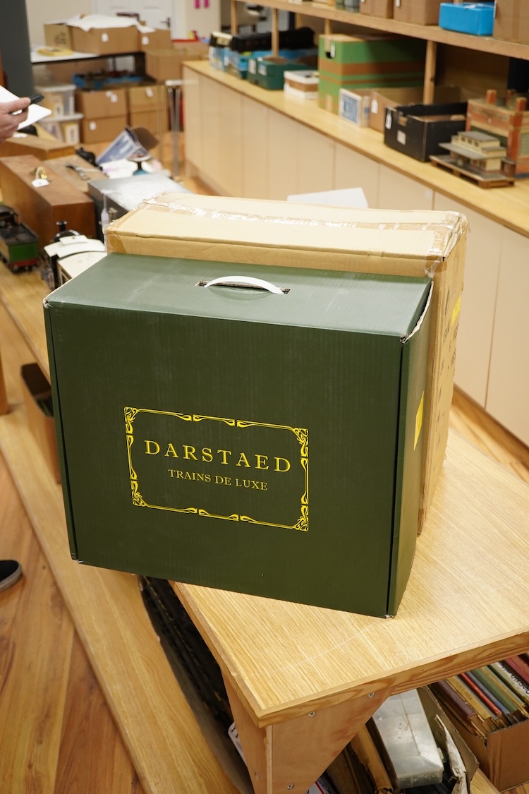 A boxed 0 gauge Darstaed tinplate Metropolitan Railway set of bogie coaches, a rake of five coaches in teak livery including; two Brake Thirds, two Full Thirds, and a Full First, fitted with internal lighting throughout